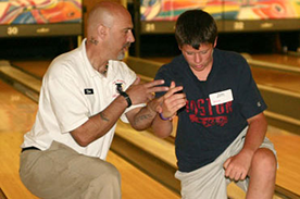 Don White assisting a student in the kneel down drill at the Dick Ritger Bowling Camp